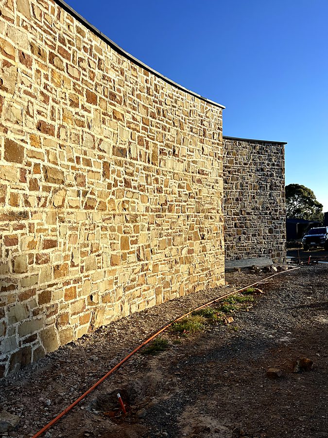Curved sandstone wall in late afternoon light