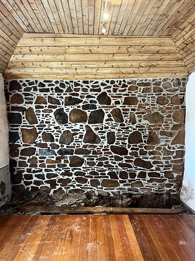 Interior heritage rubble stone wall repointed in lime mortar