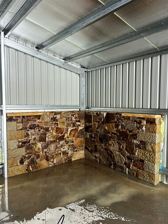 Interior stone cladding to a corner with timber capping