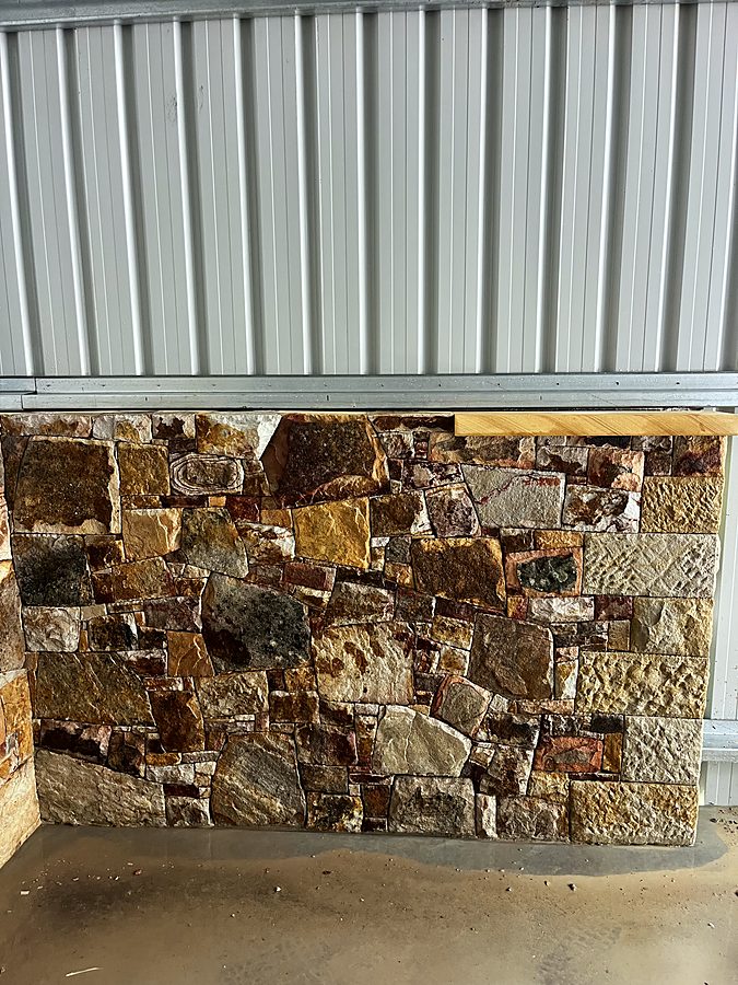Stone cladding sample panel showing colour and texture range