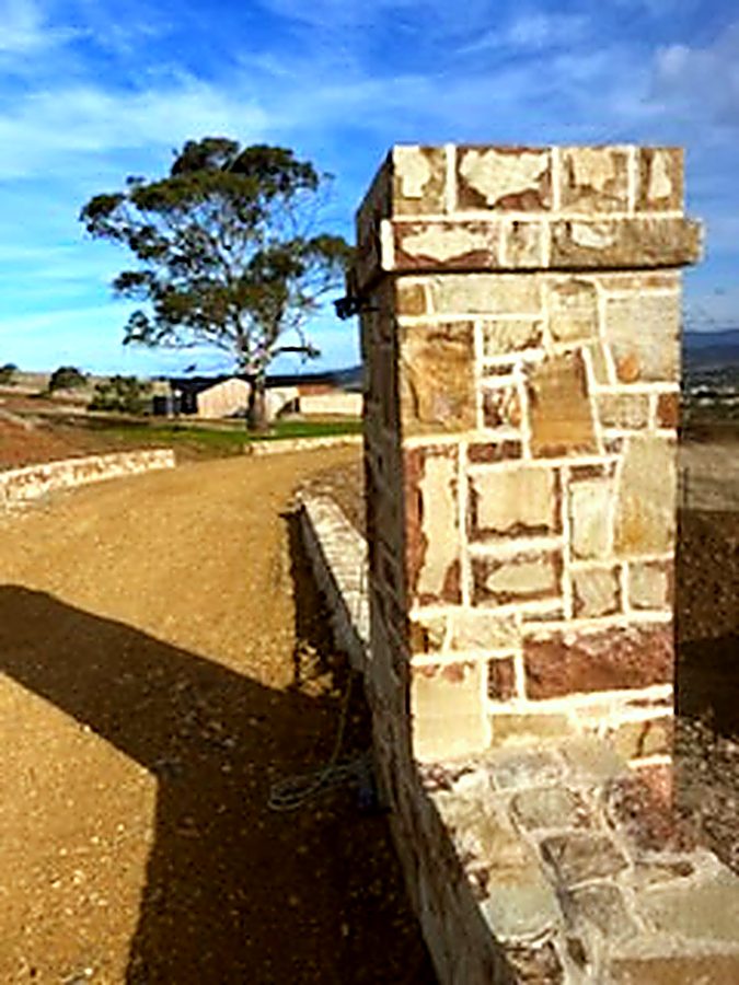 Dressed stone entry pillar beside a driveway