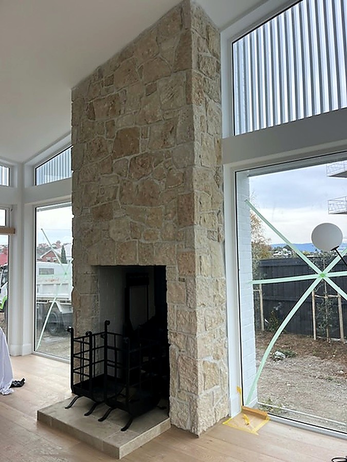 Stone chimney breast rising to a raked ceiling